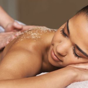 woman receiving a body scrub and massage