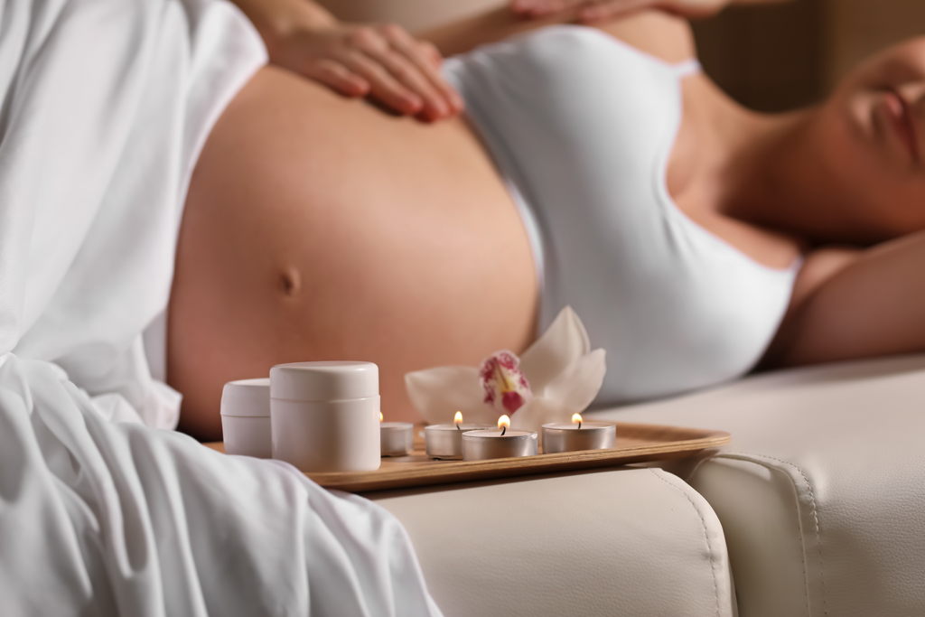 pregnant woman receiving a prenatal massage